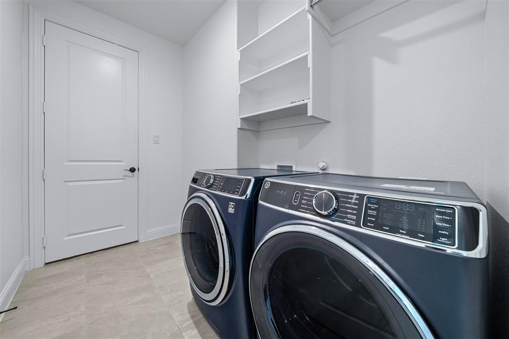 1173 Rochester Place Copper Canyon, TX 75077 - Photo 28 of 34 The laundry area features tile flooring, built-in shelving, and a white paneled door