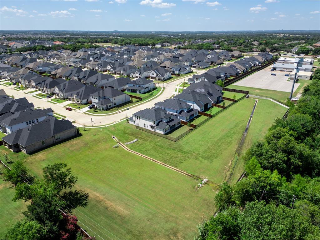 1173 Rochester Place Copper Canyon, TX 75077 - Photo 33 of 34 An aerial view showcasing the property's advantageous positioning within a residential area, featuring well-maintained homes with dark roofs and light-colored exteriors
