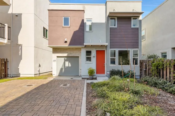a front view of a house with a garden