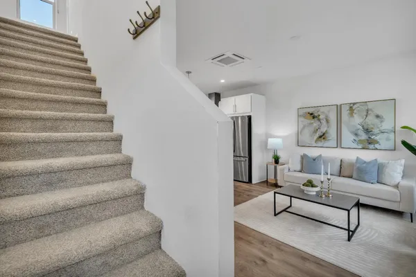 a living room with furniture and a painting