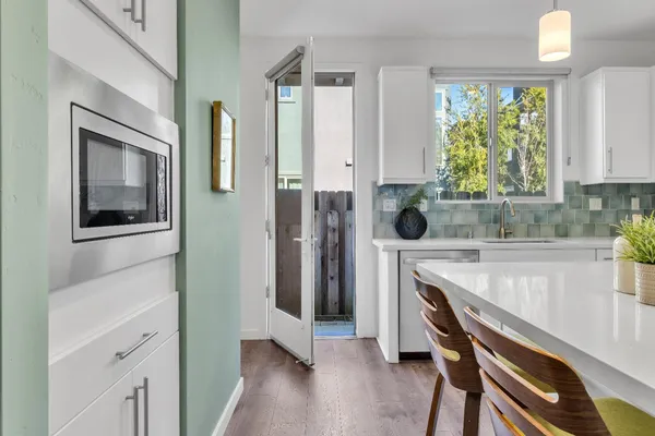 a bathroom with a granite countertop sink a mirror and shower