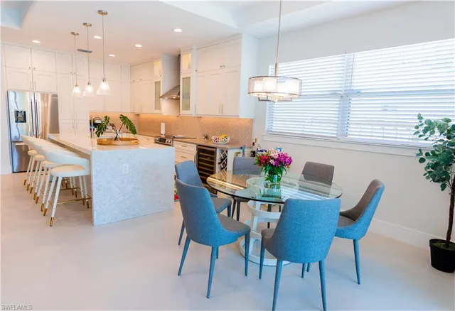 a large kitchen with stainless steel appliances granite countertop a sink and a stove