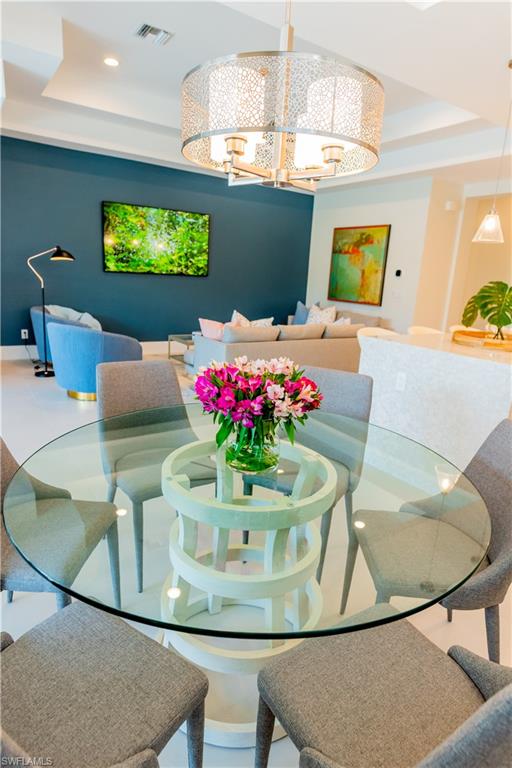 548 101st Avenue North Naples, FL 34108 - Photo 14 of 50 a view of a dining room with furniture and a chandelier