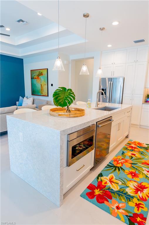 548 101st Avenue North Naples, FL 34108 - Photo 15 of 50 a kitchen that has a stove and a table