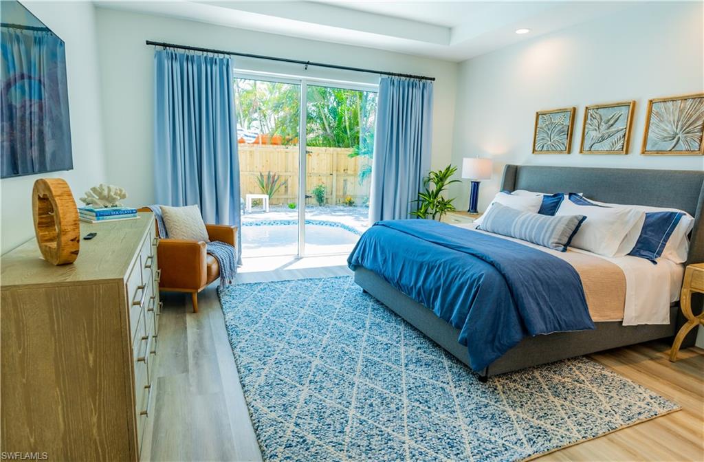 548 101st Avenue North Naples, FL 34108 - Photo 17 of 50 a bedroom with a bed and a couch