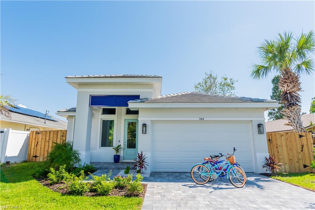 548 101st Avenue North Naples, FL 34108 - Photo 2 of 50 a front view of a house with garden