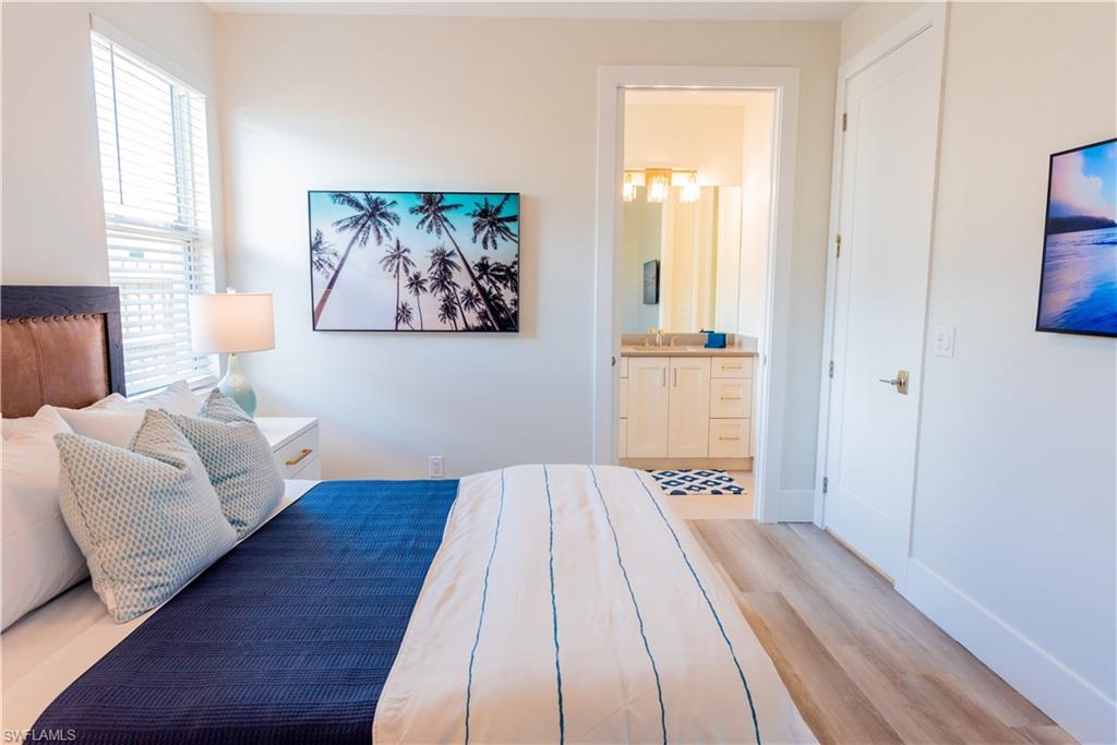 548 101st Avenue North Naples, FL 34108 - Photo 25 of 50 a view of a bedroom with wooden floor and window
