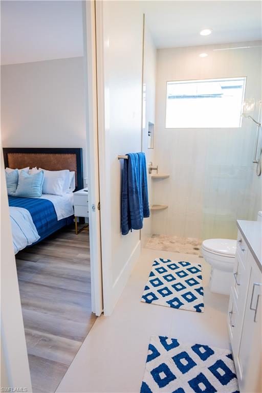 548 101st Avenue North Naples, FL 34108 - Photo 26 of 50 a bedroom with a bed and a walk in closet