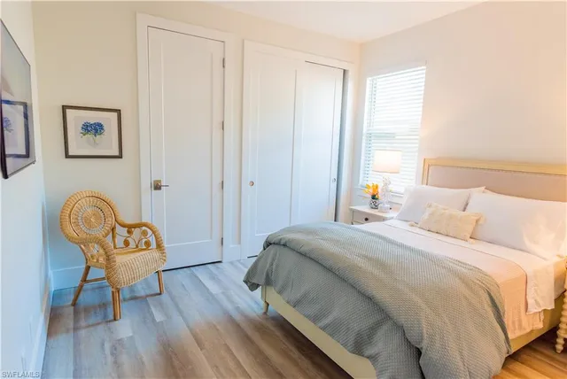 a bedroom with a bed and a night stand