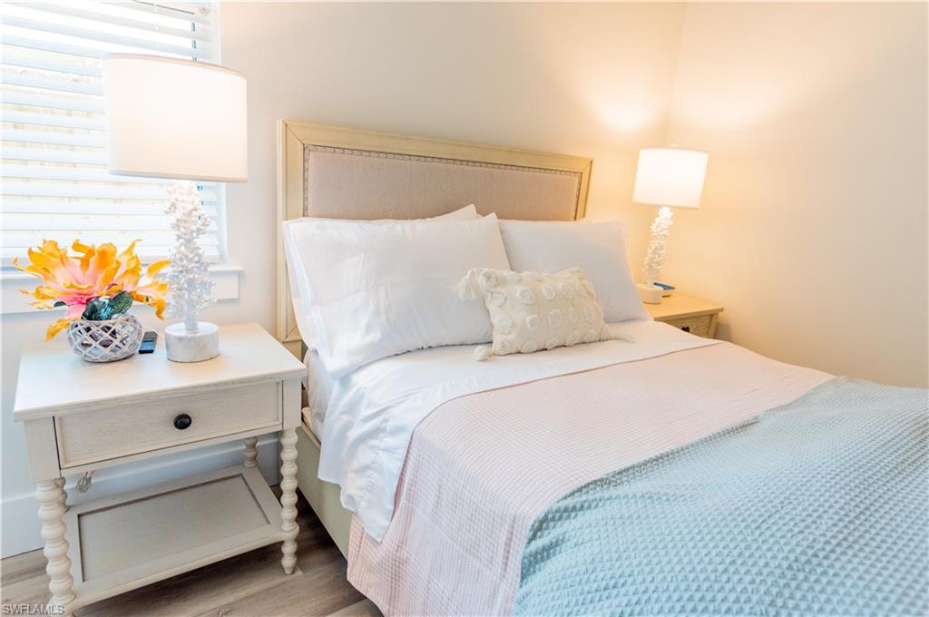 548 101st Avenue North Naples, FL 34108 - Photo 29 of 50 a bedroom with a bed and a night stand