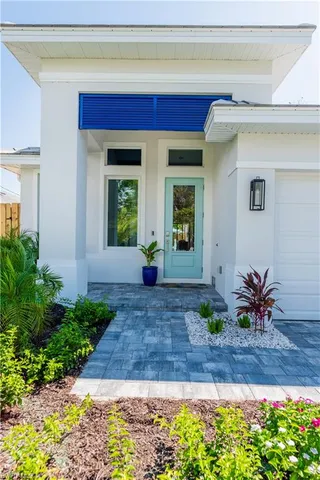 a view of front door of house with outdoor seating
