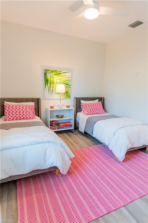 548 101st Avenue North Naples, FL 34108 - Photo 32 of 50 a bedroom with a bed and wooden floor