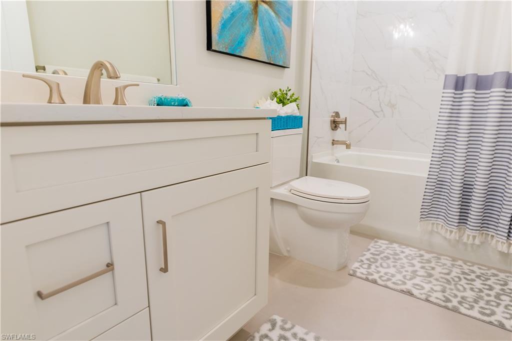 548 101st Avenue North Naples, FL 34108 - Photo 34 of 50 a bathroom with a sink a toilet and shower
