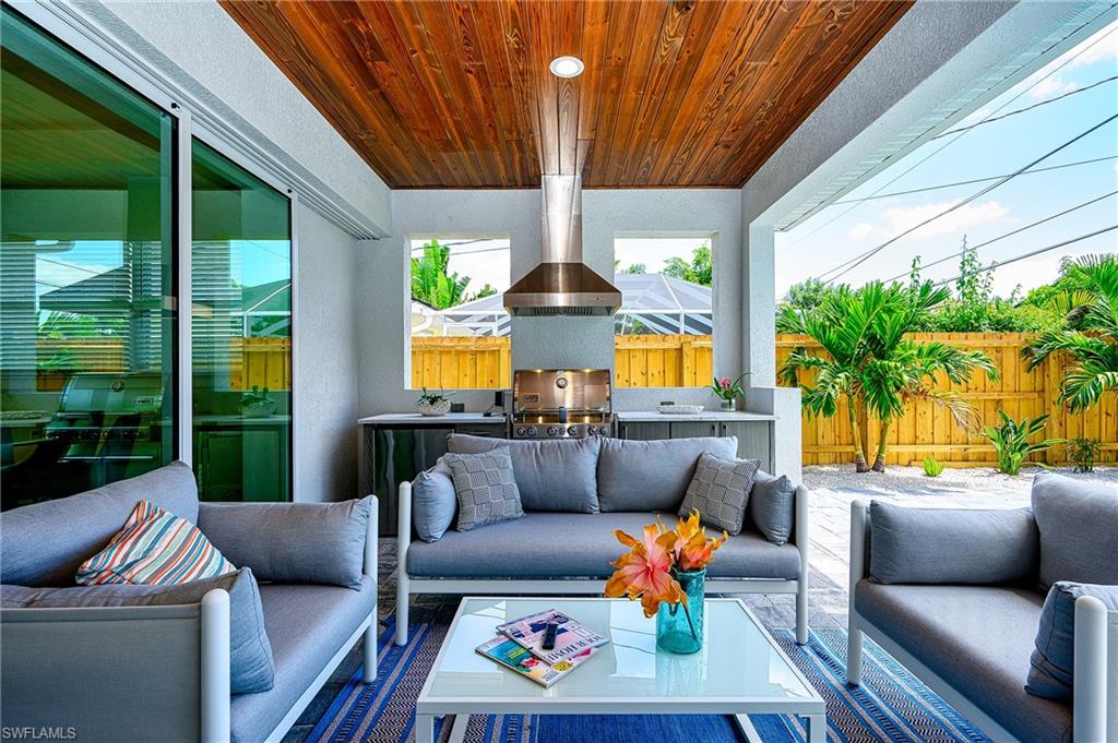 548 101st Avenue North Naples, FL 34108 - Photo 37 of 50 a outdoor living space with furniture and garden view