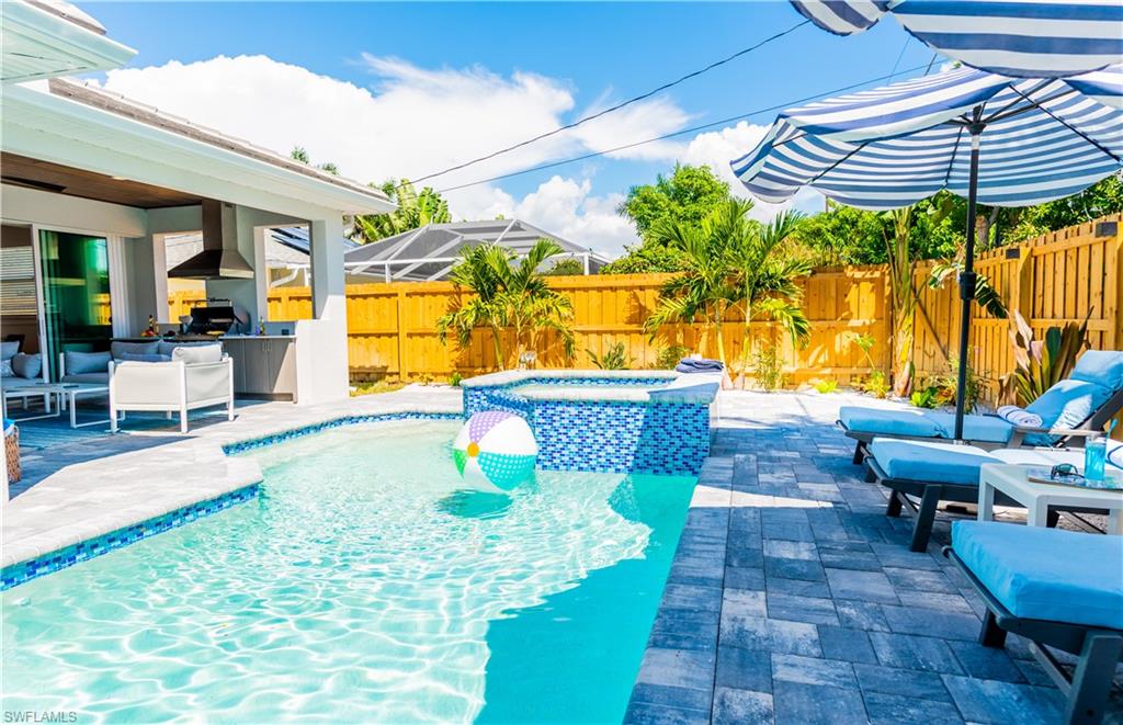 548 101st Avenue North Naples, FL 34108 - Photo 40 of 50 a swimming pool with outdoor seating and yard