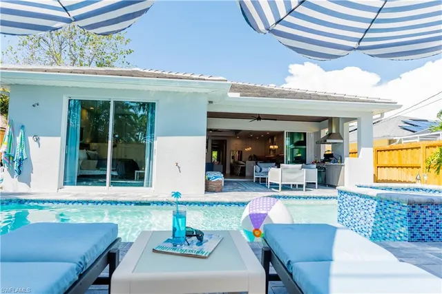 a view of a backyard with a patio table and chairs