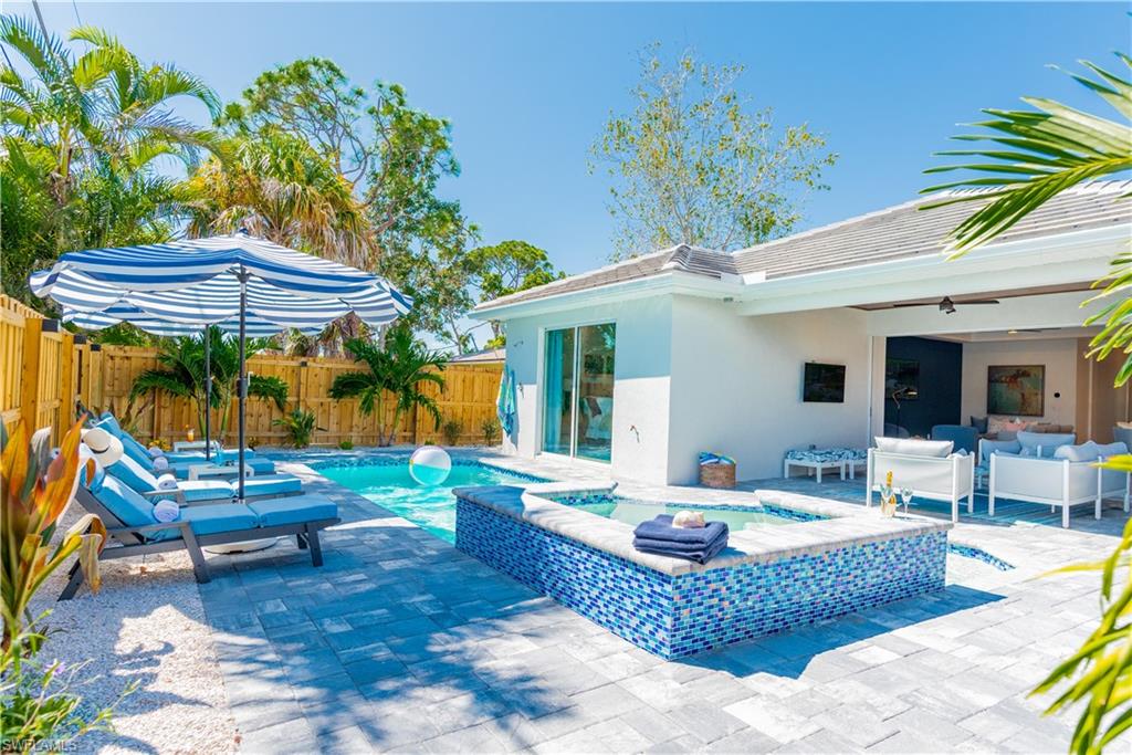 548 101st Avenue North Naples, FL 34108 - Photo 42 of 50 a view of a backyard with a patio table and chairs