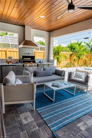 a backyard of a house with barbeque oven table and chairs