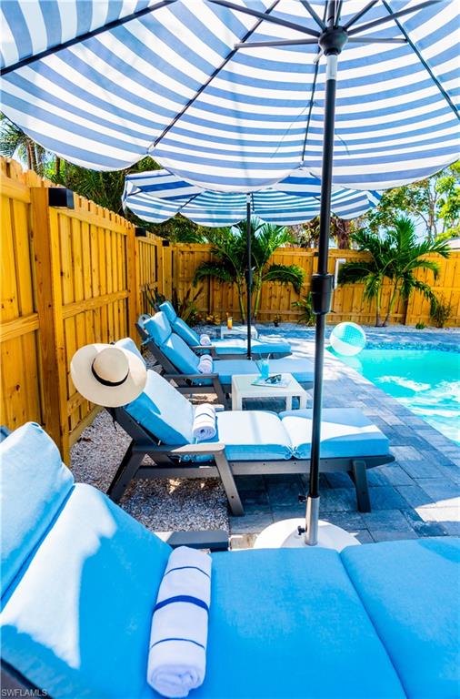 548 101st Avenue North Naples, FL 34108 - Photo 47 of 50 a backyard of a house with barbeque oven table and chairs