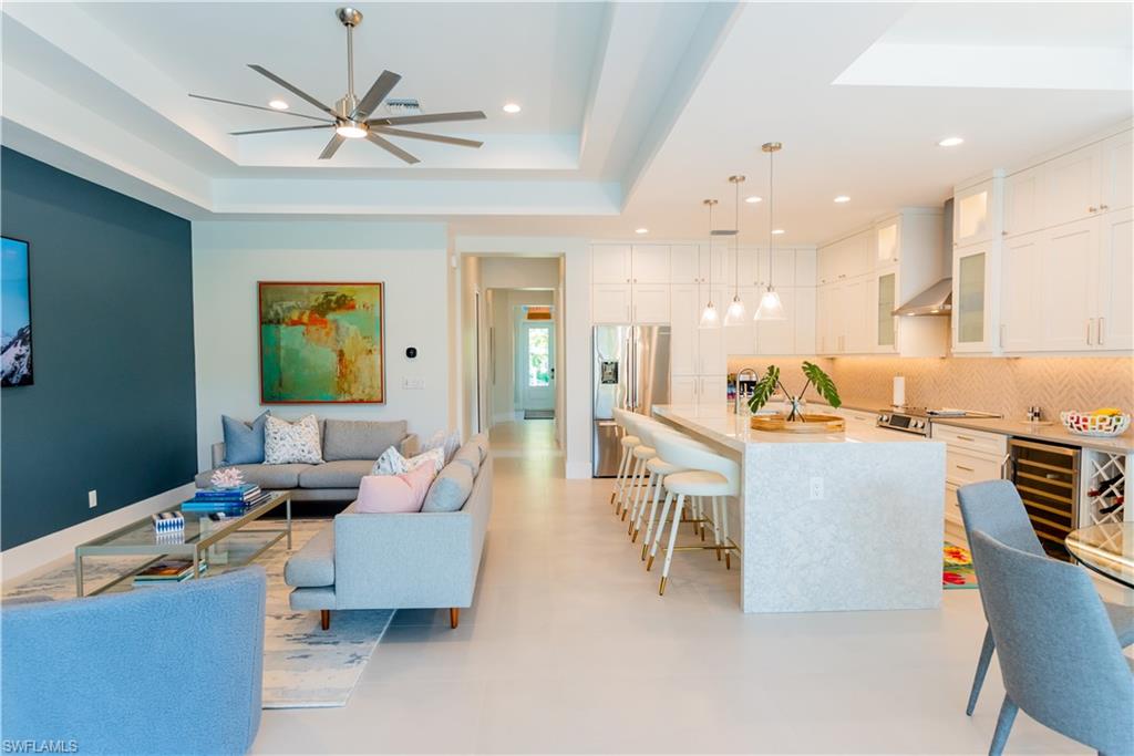 548 101st Avenue North Naples, FL 34108 - Photo 9 of 50 a living room with furniture kitchen view and a chandelier
