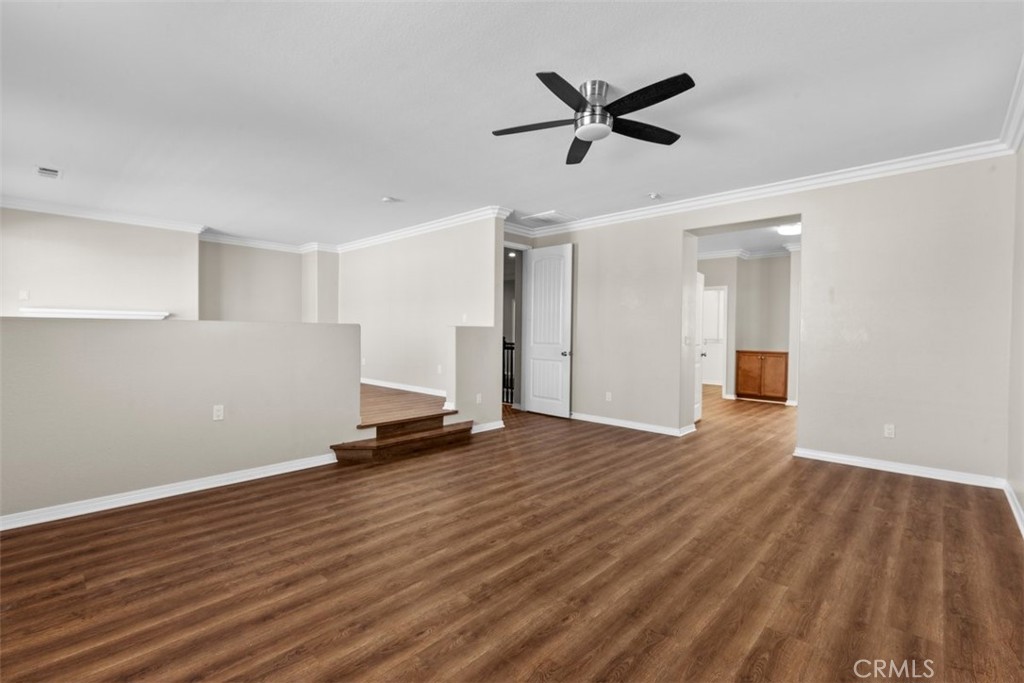 820 Volande Court Perris, CA 92571 - Photo 19 of 37 an empty room with wooden floor and a ceiling fan