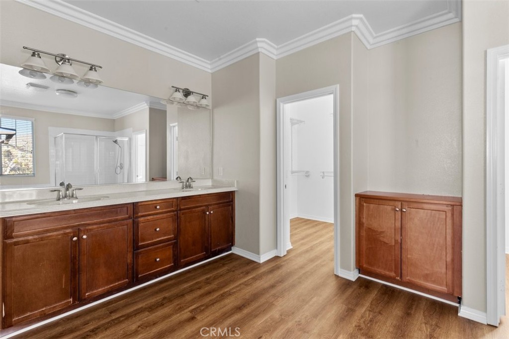 820 Volande Court Perris, CA 92571 - Photo 21 of 37 a spacious bathroom with a granite countertop sink and mirror