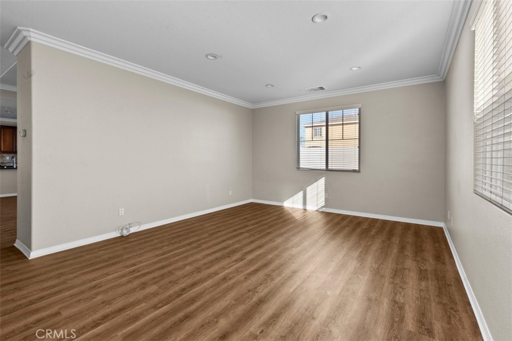 820 Volande Court Perris, CA 92571 - Photo 30 of 37 a view of empty room with wooden floor and fan