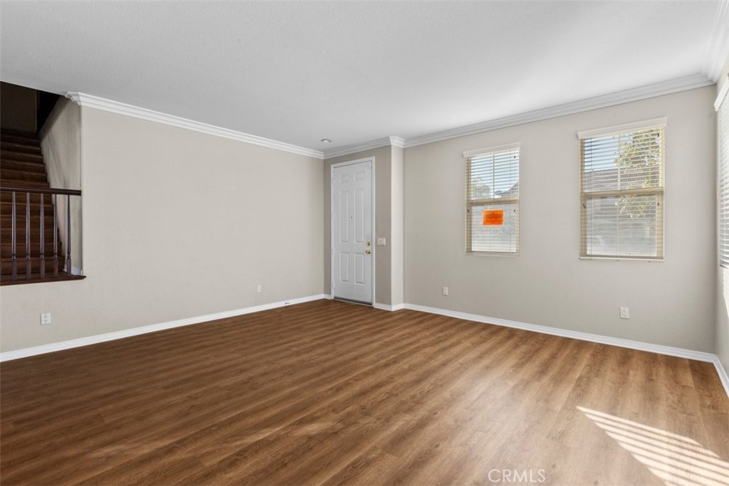820 Volande Court Perris, CA 92571 - Photo 33 of 37 a view of an empty room with wooden floor and a window