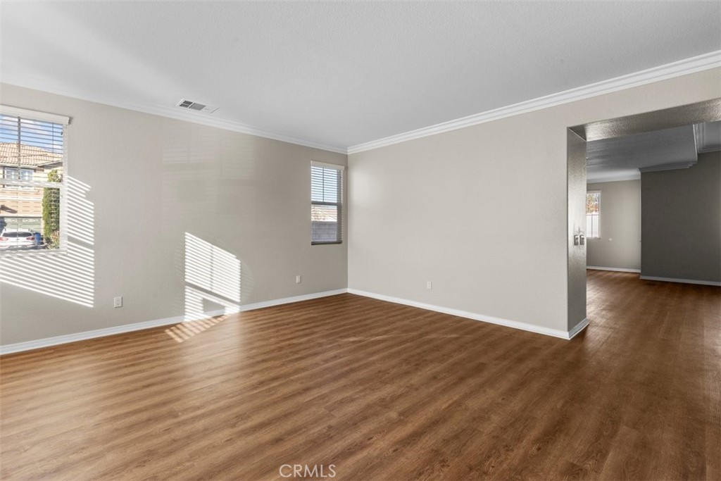820 Volande Court Perris, CA 92571 - Photo 34 of 37 a view of an empty room with wooden floor and a window