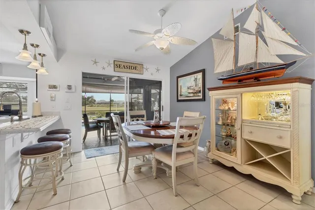 a dining room with kitchen island granite countertop furniture and a view of kitchen
