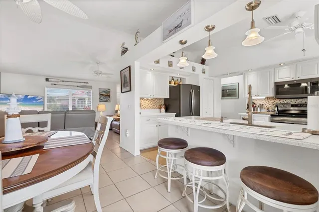a kitchen with cabinets and stainless steel appliances