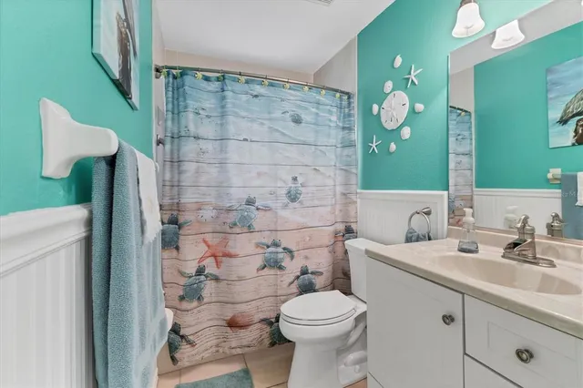 a sign of golf club on a wall under a tree