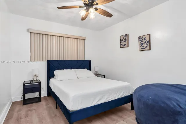 a bedroom with a bed and a ceiling fan
