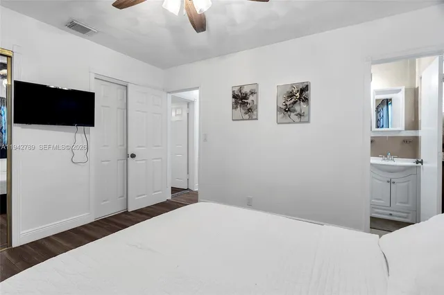 a bedroom with a bed and a television