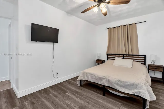 a bedroom with a bed and a flat screen tv