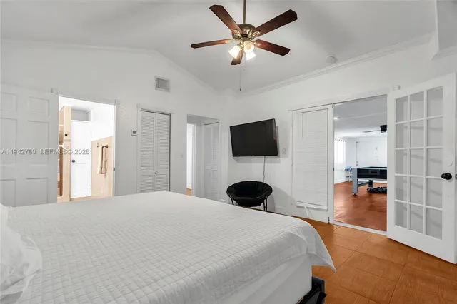 a bedroom with a bed and a flat screen tv