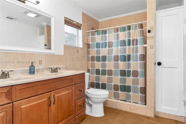 a bathroom with a sink toilet a mirror and shower