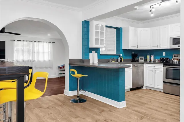 a kitchen with a sink a stove cabinets and counter space