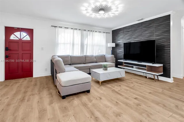 a living room with furniture and a flat screen tv