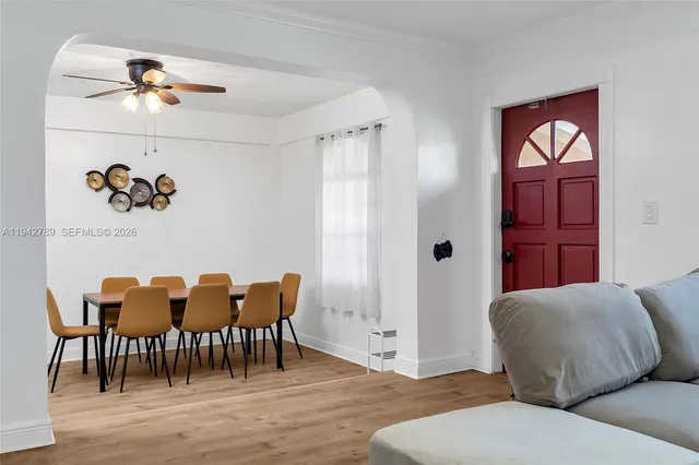 a living room with furniture and wooden floor