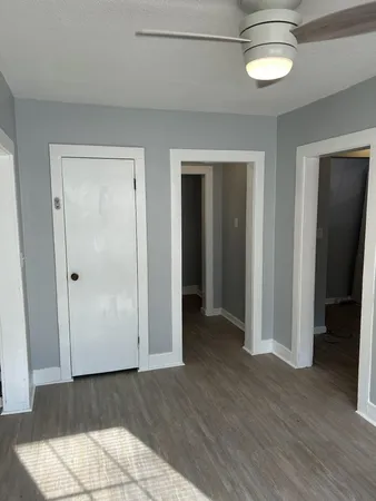 an empty room with wooden floor and closet