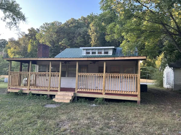a view of a wooden deck with a yard