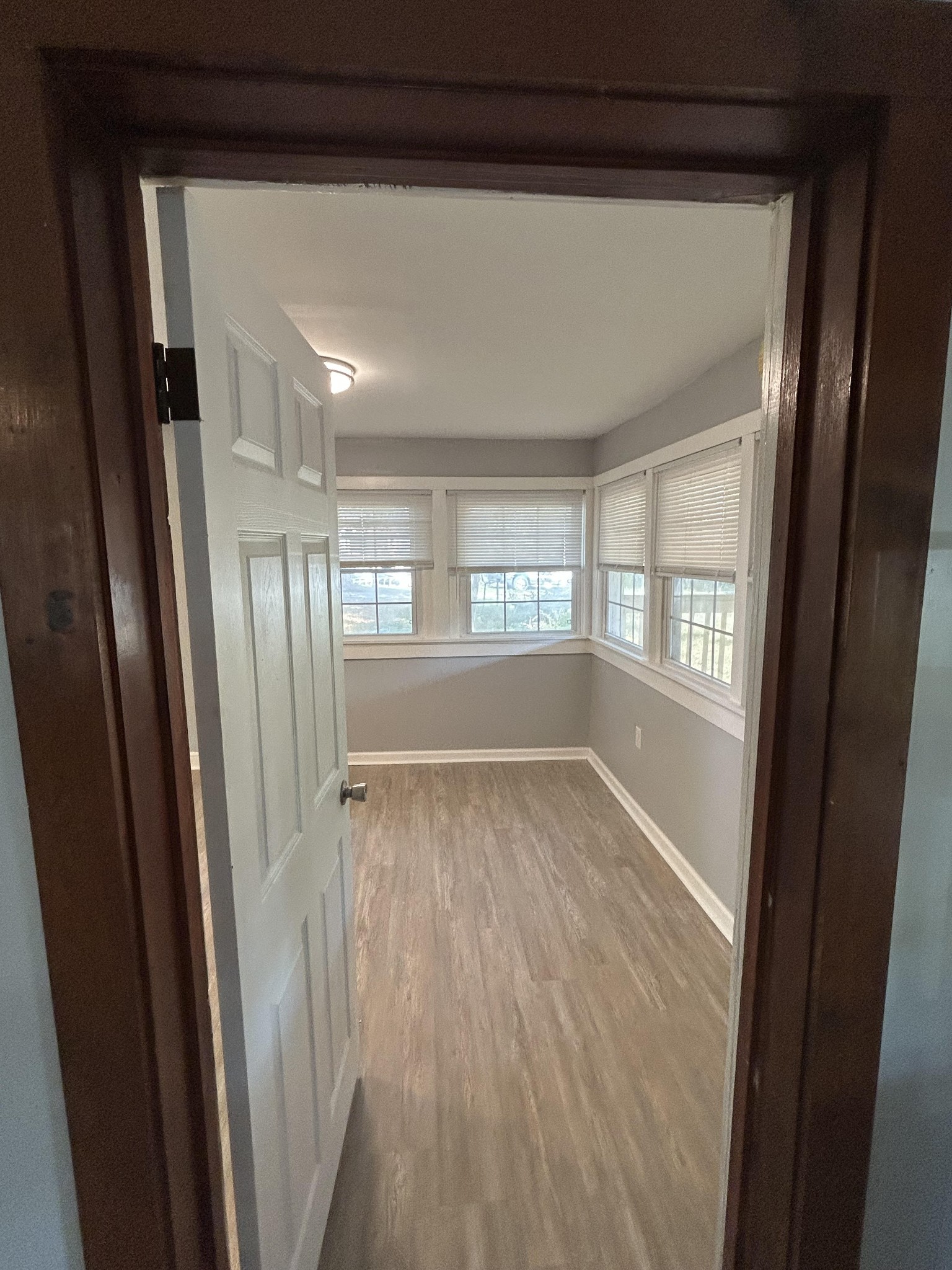 95 Front Street Stewart, TN 37175 - Photo 22 of 31 a view of an empty room with wooden floor and a window