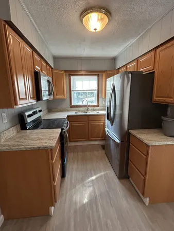 a kitchen with refrigerator and window