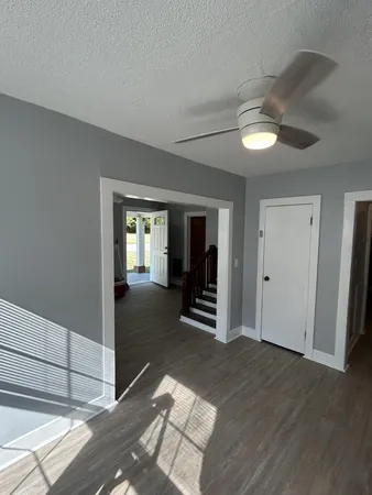 a view of a room with wooden floor and window