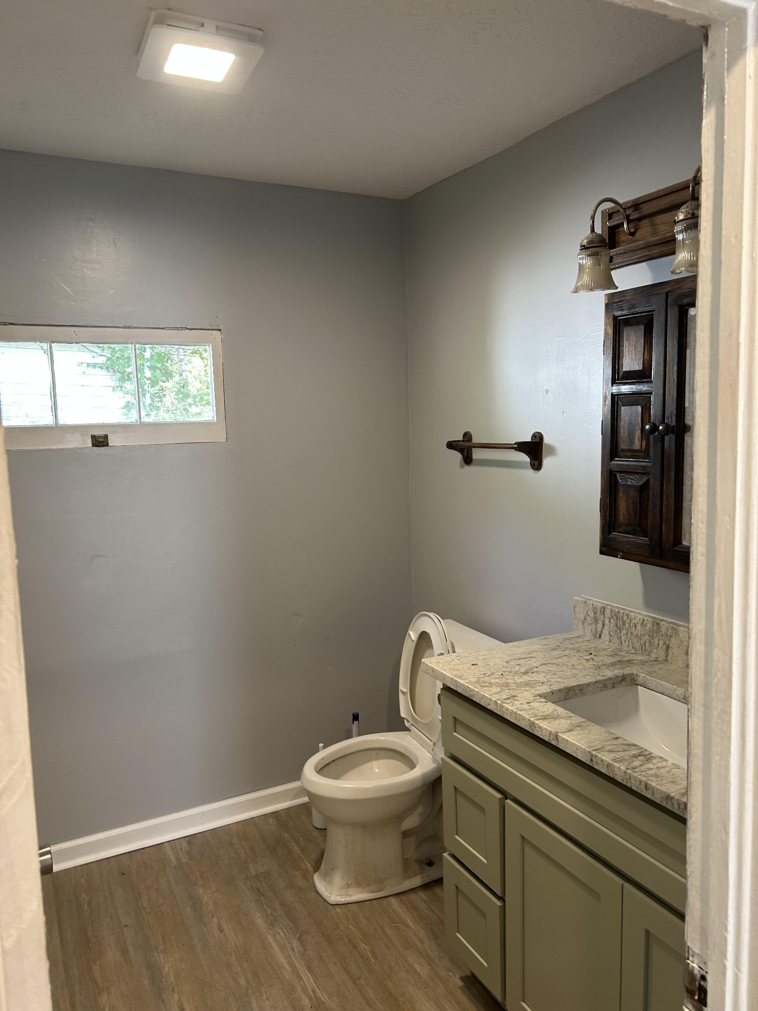95 Front Street Stewart, TN 37175 - Photo 29 of 31 a bathroom with a granite countertop toilet and a sink