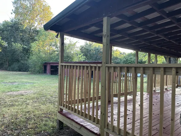 a view of a backyard with wooden floor barbeque and outdoor seating