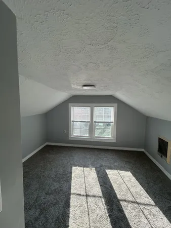 an empty room with a empty space and windows