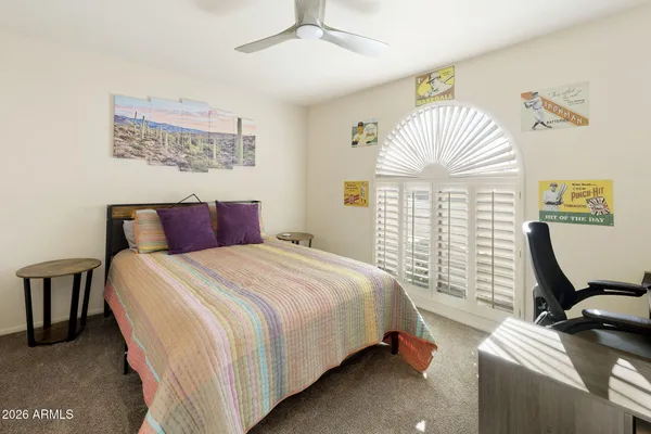a bedroom with bed and window