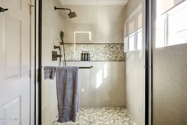 a bathroom with a shower and a sink